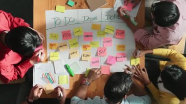 Renkli yapışkan notlarda pazarlama ve planlama stratejisi yazarken insanların yazma ve çalışma tahtası oluşturma konusunda üst düzey bir bakış açısı. Akıllı takım Kanaban tahtasını kullanarak iş performansını yönetir. Cemaat.