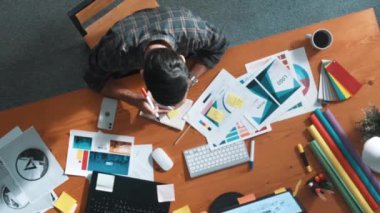 Rengi seçerken akıllı iş adamının müdürü aramasının havadan görüntüsü. Toplantıda ürün için ana tema rengini seçerken ve tasarlarken dizüstü bilgisayara bakan profesyonel iç mimar. Sempozyum.