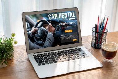 car rental website on computer screen for tourist to rent a car for transportation snugly