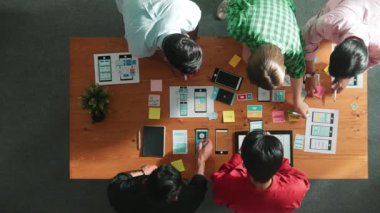 Mobil telefon arayüzü için Ux Ui tasarımı planlarken iş adamlarının yapışkan notlar üzerine yazı yazma fikrine tepeden aşağı bakış açısı. Bir grup yaratıcı tasarımcı kablo prototip tasarımı üzerinde çalışıyor. Cemaat.