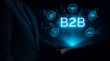 İş adamı B2B peyzajında geziniyor, iş-iş bağlantılarını geliştirmek için kullanım teknolojisi kullanıyor. B2B etkileşimini yeniden şekillendiren keşifler, iş-iş stratejilerinde yenilikleri yönlendiren araçlar. Kullanıcı Kimliği