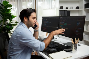 Akıllı IT geliştirici yöneticisi, bilgisayar ekranındaki yazılım kodlama sistemindeki sorunu çözen iş arkadaşına seslenerek modern ofiste uygulama programı güncellemesi yapıyor. Tahmin et..