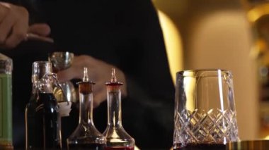 İçki şekerini ölçmek için elinde jigger tutan yakın el barmeni bardakları karıştırmak için alkol hazırlama yaratıcı karışım. Gece hayatı karışımı sergilenen özel bir içecek. Vinosity.