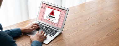 Cyber attacking concept. Malware alert showing on computer screen display scam and threat detection on computer system or online server to be removed snugly.