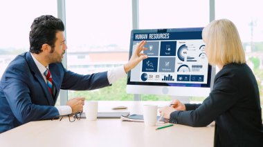 Human resources management software on computer screen helping human resources employee to manage recruitment, payroll, staff searching and KPI evaluation snugly