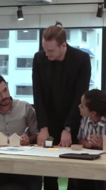 Yaratıcı iş adamları modern işyerindeki ofis masasında sohbet ediyorlar. Şirket uluslararası iş kavramı.