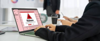 Cyber attacking concept. Malware alert showing on computer screen display scam and threat detection on computer system or online server to be removed snugly.