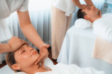 Kafkasyalı çift stres önleyici kafa masajının keyfini çıkarıyor ve lüks otellerde ya da otel spa salonlarında gündüz kaplıcalarında yüz güzelliği eğlencelerini şımartıyor. Sessiz.