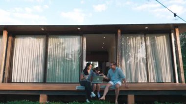 Şirin baba, anne ve kızı birlikte evin bahçesinde oturuyorlar. Ebeveynler, çevre farkındalığıyla ilgili genç nesli iletişim kurmak için açık hava aktivitelerini kullanırlar. Uyumsuzluk.