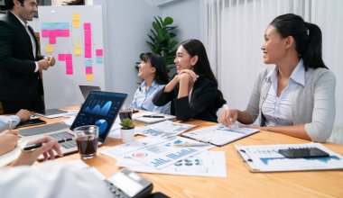 Ofis masasındaki finansal veri raporlarını analiz eden çeşitli bir grup iş analisti. Stratejik pazarlama planlaması için iş istihbarat analizine göre grafikler ve grafikler.