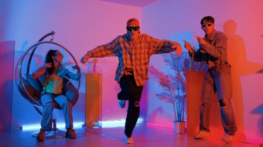 Stüdyoda gündelik kıyafetleri olan çok kültürlü bir arkadaş tezahürat yaparken mutlu hipster break dansları. Profesyonel sokak dansçısı hip hop ritmi ya da neon veya kurşun ışıkla kafiyeli bir şarkı söyler. Mutluluk.