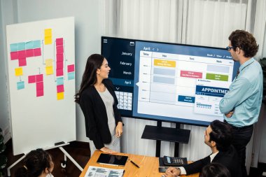 Proje yöneticisi toplantı odasında iş programları, Gantt program programı TV ekranında. Çoklu etnik çeşitlilik iş adamları ve modern iş projesi yönetimi. Çok titiz.