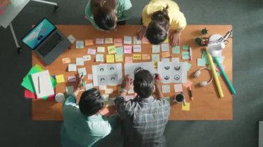 İş dünyasının zaman atlaması renkli notlarla toplantı masasına grafik logosu koydu ve fikri açıklarken tasarım yapmaya başladı. Proje yöneticisi grup halinde yürürken konsept sanatı anlatıyor. Sempozyum.