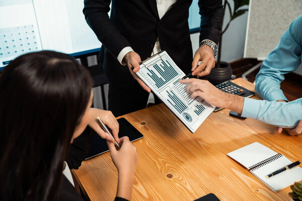 Разнообразная группа бизнес-аналитиков, анализирующих отчеты по финансовым данным на офисном столе. Диаграмма и график анализа бизнес-аналитики для стратегического маркетингового планирования Habiliment