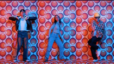 Parti sahnesinde kameraya bakarken balon geçmişiyle birlikte dans eden mutlu çok kültürlü dansçılar. Zeki hipster grubu müzik yapıyor ve sokak dansı yapıyor. Tam vücut. Mutluluk.