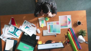 Top down aerial view of skilled interior design graphic talking to manager by using phone. Project manager working while using telephone and listen to team and discuss building design idea. Symposium.