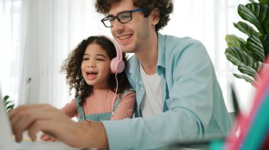 Caucasian dad put headphones on daughter while girl learning code. Father take care schoolgirl while teaching writing engineering prompt and generate Ai by using laptop. Online learning. Pedagogy. clipart