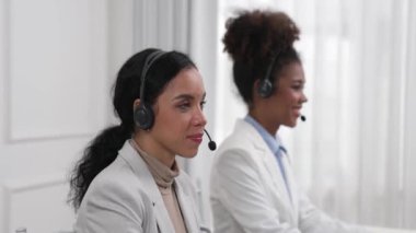 Ofiste çalışan kulaklık takan işadamları uzak müşteri ya da meslektaşlarını desteklemek için çalışıyorlar. Çağrı merkezi, tele pazarlama, müşteri destek acentesi telefon görüntülü konferans görüşmesi için hayati önem taşıyor.