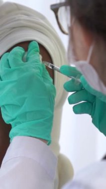 Genç adam aşılar için yetenekli doktorları hastanede ziyaret ediyor. Covid 19 ve Coronavirus Aşı Merkezi Hizmet Konsepti .