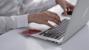 Kadın alışverişi ya da internet pazarında online ödeme modern yaşam tarzı için satılık eşyalar arıyor ve canlı siber güvenlik yazılımı tarafından korunan cüzdandan çevrimiçi ödeme için kredi kartı kullanıyor