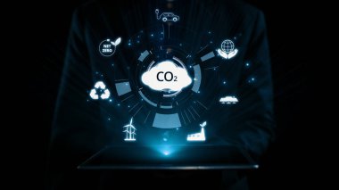 İş adamı CO2 emisyonlarını azaltmak için girişimlerde bulunuyor ve net sıfır hedefliyor. Daha yeşil bir gezegenin karbondioksitini azaltarak sürdürülebilirliğe olan bağlılığını gösteriyor. Kullanıcı Kimliği