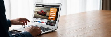 car rental website on computer screen for tourist to rent a car for transportation snugly