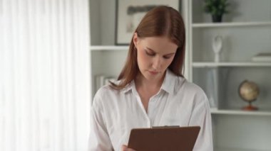 Psikiyatri ofisinde ya da terapi odasında kol koltuğunda oturan profesyonel bir kadın psikolog. Arkadaş canlısı ve ilkel ruh sağlığı danışmanı ve terapisti.