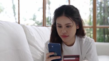 Kadın alışverişi ya da internet pazarında online ödeme modern yaşam tarzı için satılık eşyalar arıyor ve canlı siber güvenlik yazılımı tarafından korunan cüzdandan çevrimiçi ödeme için kredi kartı kullanıyor