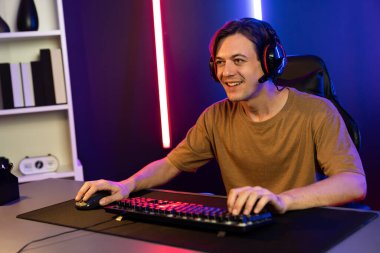 Kazanmak için çevrimiçi oyun oynayan akıllı flama makinesinin sunucu kanalı, neon ışıklı odada seçilen takım yarışması için izleyicilerle birlikte canlı yayında canlı yayında kulaklık takıyor. Bireysel.