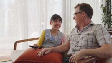 Büyükbaba ve torun birlikte TV 'de ilginç bir eğlence medyası izliyorlar. Eski üst düzey kullanım teknolojisi, genç nesil çapraz nesil ile iletişim kurarak aile bağlarını güçlendiriyor. Uyumsuzluk.