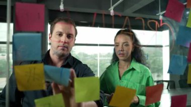 Yetenekli işadamı pazarlama fikrini cam duvardaki proje yöneticisine sundu. Yönetici projeyi yatırımcıya açıklıyor. Zeki iş adamları birlikte çalışıyor, beyin fırtınası yapıyorlar. Yönlendirici.