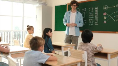 Kafkas öğretmeni matematik dersinde tahtaya cevap yazmak için gönüllü buldu. Öğretmen, öğrenciye tebeşir verilirken ve sınıfın önünde yürürken soruyu cevaplamak için gönüllü olmayı talep ediyor. Pedagoji.