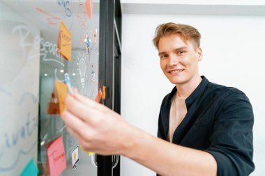 Kafkasyalı profesyonel iş adamının zihin haritası ve renkli yapışkan notlar kullanarak iş pazarlama fikrini kendine güvenle sunuşunun yakın görüntüsü. Proje konseptini başlat. Portre. Tertemiz..