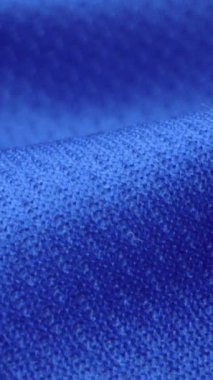 Parlak spandeks likra kumaşının detaylı kumaş dokusunu kapayın ve makro yakın plan çekimde doli ile akın edin. Dalgalı, temiz elastik dokuma malzemesi. Tekstil soyut arka planı. Kıyafet endüstrisi konsepti.