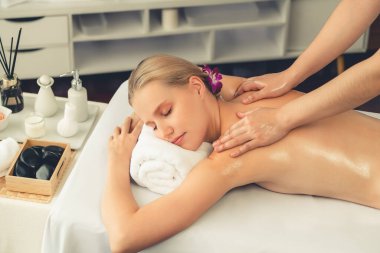 Kafkasyalı kadın müşteri stres önleyici spa masajının keyfini çıkarıyor ve lüks otel ya da oteldeki gündüz açık ortam güzellik salonunda güzellik teniyle eğleniyor. Sessiz.