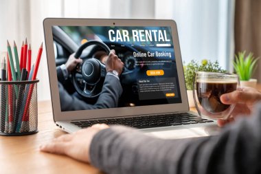 car rental website on computer screen for tourist to rent a car for transportation snugly