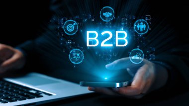 İş adamı B2B peyzajında geziniyor, iş-iş bağlantılarını geliştirmek için kullanım teknolojisi kullanıyor. B2B etkileşimini yeniden şekillendiren keşifler, iş-iş stratejilerinde yenilikleri yönlendiren araçlar. Kullanıcı Kimliği