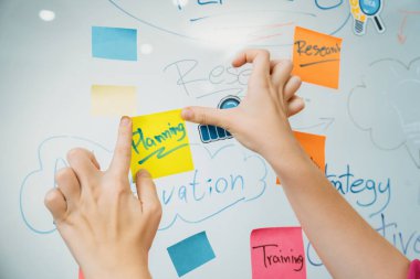 Profesyonel iş kadınının elini kapat ve iş planını sunarken renkli yapışkan notları beyaz tahtaya yapıştır. Yaratıcı iş toplantısı ve beyin fırtınası konsepti. Tertemiz..