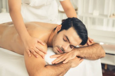 Kafkas erkek müşteri stres önleyici spa masajının keyfini çıkarıyor ve lüks otel veya oteldeki gündüz açık hava ortamında güzellik derisi eğlencesi ile şımartıyor. Sessiz.