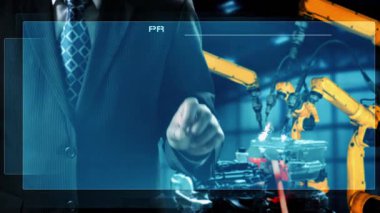 Engineer use cybernated robotic software to control industry robot arm in factory . Automation manufacturing process controlled by specialist using IOT software connected to internet network .