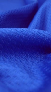 Parlak spandeks likra kumaşının detaylı kumaş dokusunu kapayın ve makro yakın plan çekimde doli ile akın edin. Dalgalı, temiz elastik dokuma malzemesi. Tekstil soyut arka planı. Kıyafet endüstrisi konsepti.