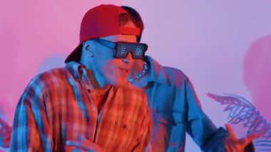 Break dansçı takımının modern stüdyoda pembe ışıkla dans etmesini kapatın. Çok kültürlü insanlar moda kıyafetleri giyerek hip hop müziğine geçiyorlar. Çılgın, komik bir ruh hali. Mutluluk.