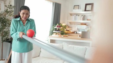 Büyükannenin elinde boru var ve göz, el koordinasyonunu geliştirmek ya da odaklanma ve konsantrasyonu arttırmak için top yuvarlama oyunu oynuyor. Yaşlı çift stresi azaltıyor. Sağlık hizmetleri. Myrmidon.