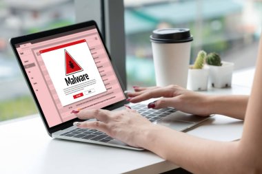 Cyber attacking concept. Malware alert showing on computer screen display scam and threat detection on computer system or online server to be removed snugly.