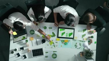 Yönetici yöneticisinin üst görünümü toplantılarda tablet temiz enerji gösterir. İş adamlarının sürdürülebilir çevre yatırımlarını planlamak ve yatırım yapmak için birlikte çalıştıklarına dair havadan bir bakış açısı. Hizalama.