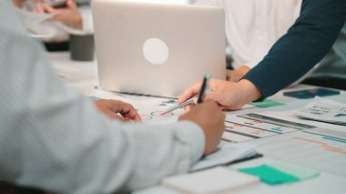 Bu görüntü, profesyonellerin veri analizi ve strateji geliştirme, modern bir çalışma alanında işbirliği ve iletişim sergiledikleri dinamik bir iş toplantısı kaydediyor. SACTR