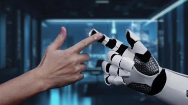 Bir insan elinin modern ofis ortamında temas simgeleriyle robotik bir ele uzandığını gösteren bir video, gelecekteki iletişim ve işbirliğini sembolize ediyor. Auvana