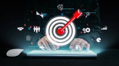 Bu resim, dijital pazarlama stratejisine uygulamalı bir yaklaşımı, teknoloji odaklı bir ortamda kilit hedefleri ve iş ölçütlerini temsil eden hedef ve simgeleri gözler önüne seriyor. Dörtgen