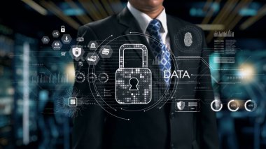 Takım elbise giymiş bir işadamı, bugün dijital dünyada veri güvenliğinin ve korunmanın önemini vurgulayan fütüristik bir geçmişe karşı duruyor. Dörtgen