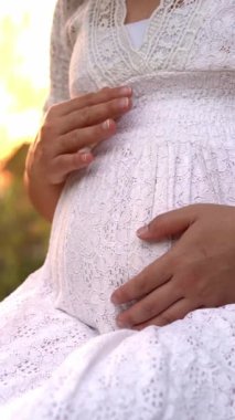 Hamile bir kadın, çocuğuna bakarken bahçe evinde mutlu bir hayat yaşıyor. Hamile karnında bebek taşıyan hamile bir anne. Doğum öncesi bakım ve kadın hamileliği konsepti.